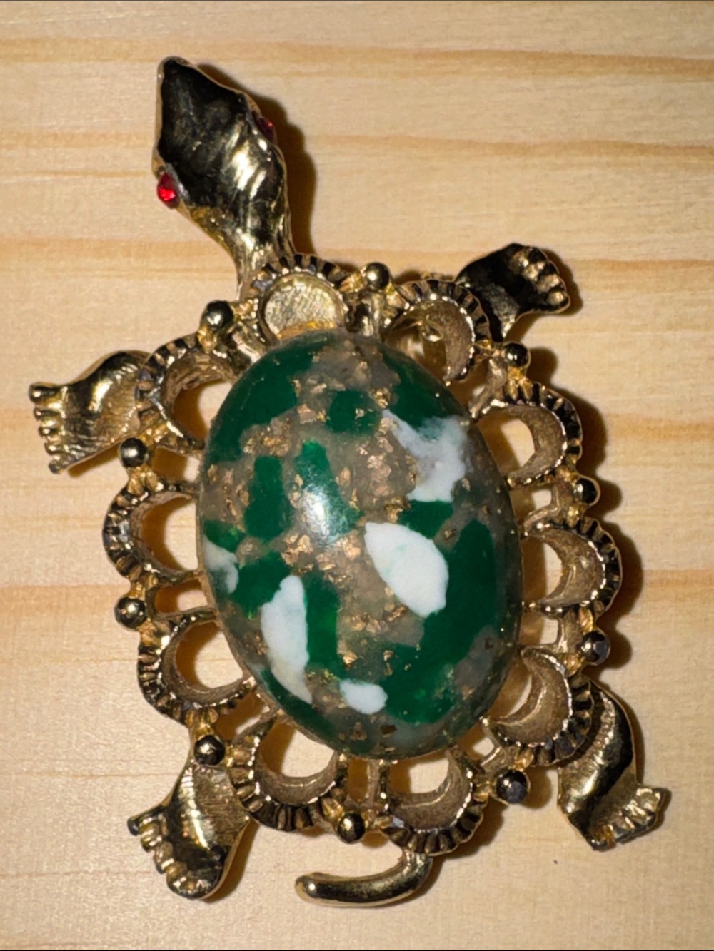 Vintage 1960s gold-tone turtle brooch with a green marbled stone.